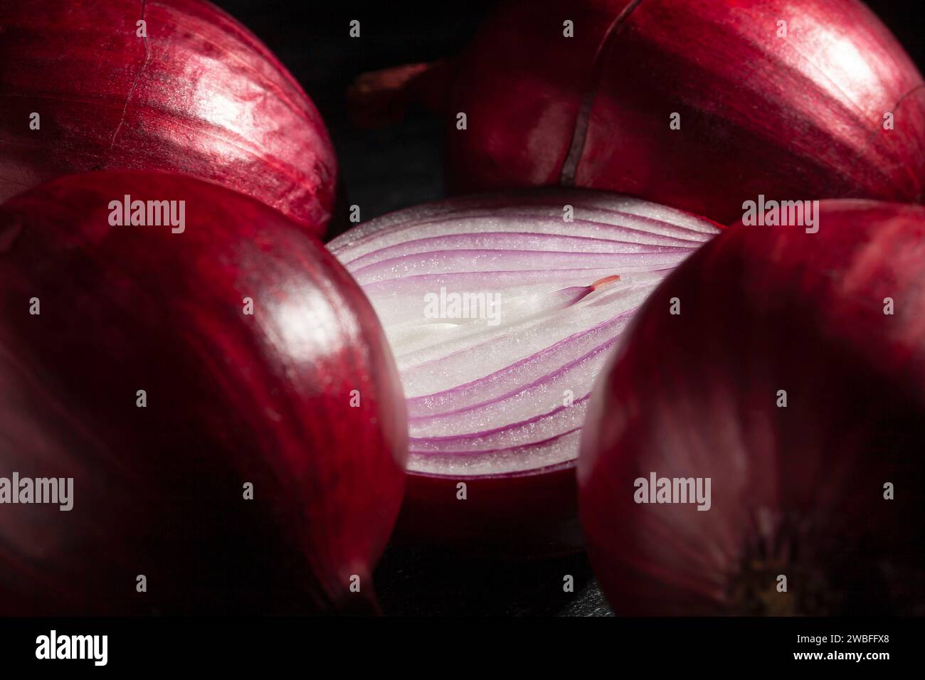 sliced red onion on black background Stock Photo
