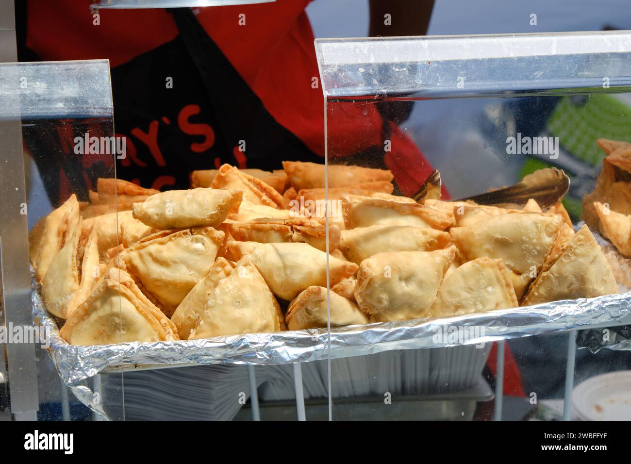 Samosas on offer at food stand in outdoor food festival Stock Photo
