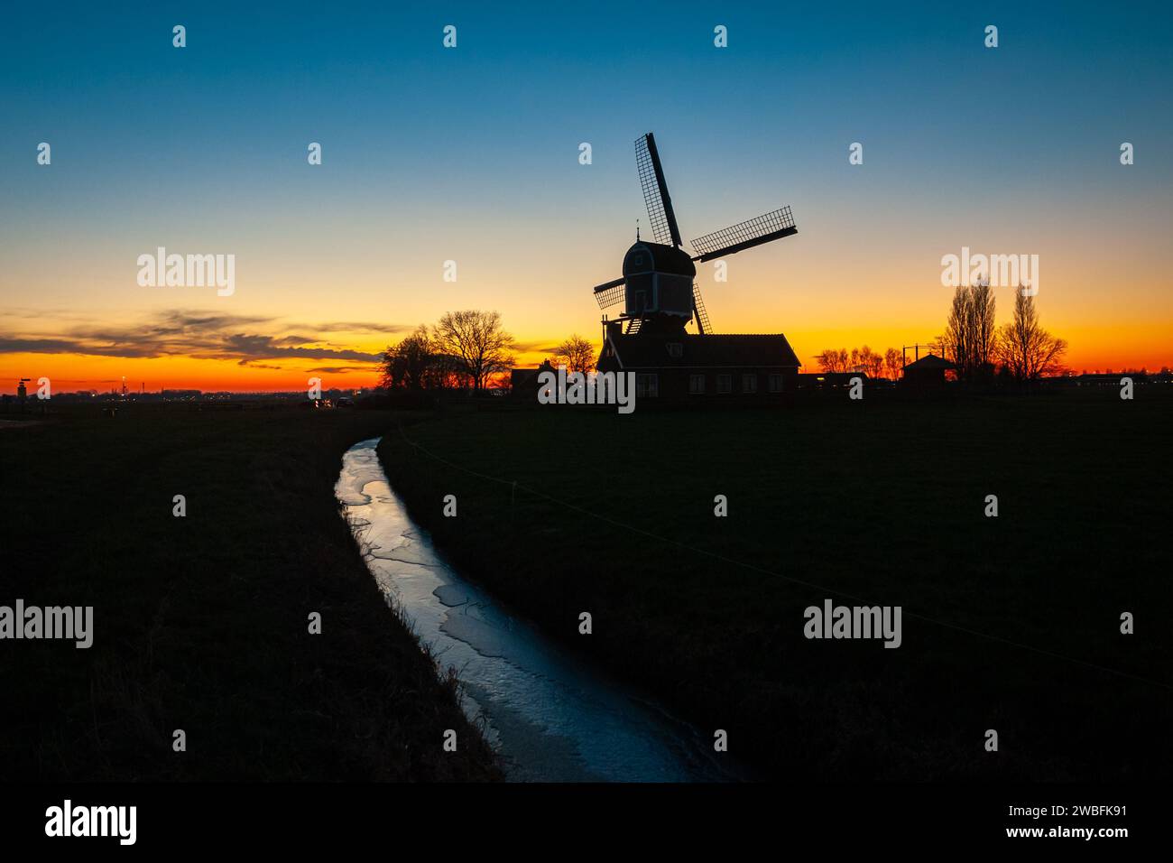 Classic windmill in the Dutch countryside on a cold wintry evening Stock Photo