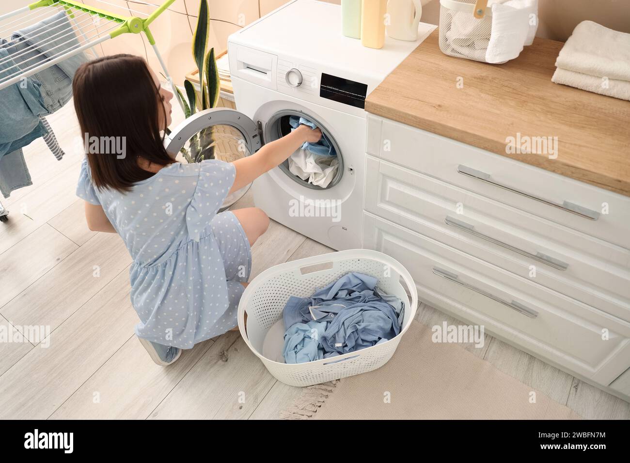 Young pregnant woman doing laundry at home Stock Photo Alamy