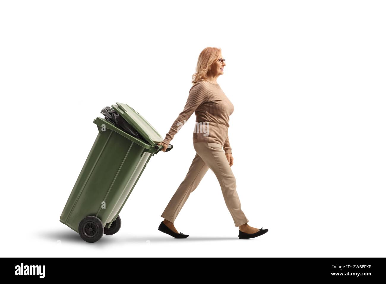 Woman walking and pulling a waste bin isolated on white background Stock Photo