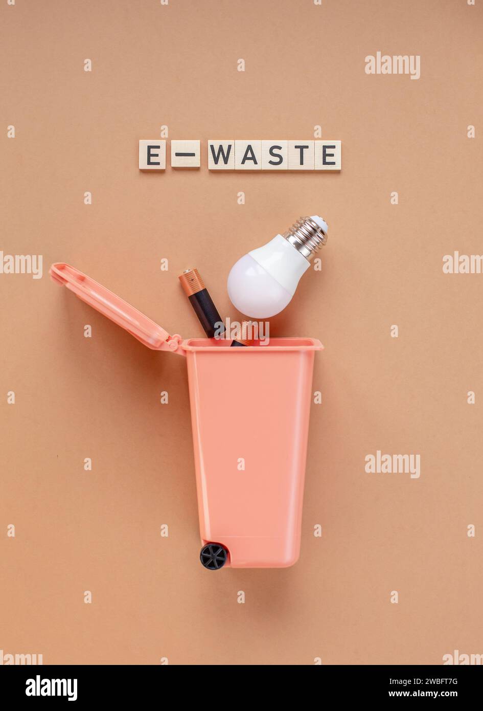 LED bulb and batteries in the trash can. Garbage sorting concept