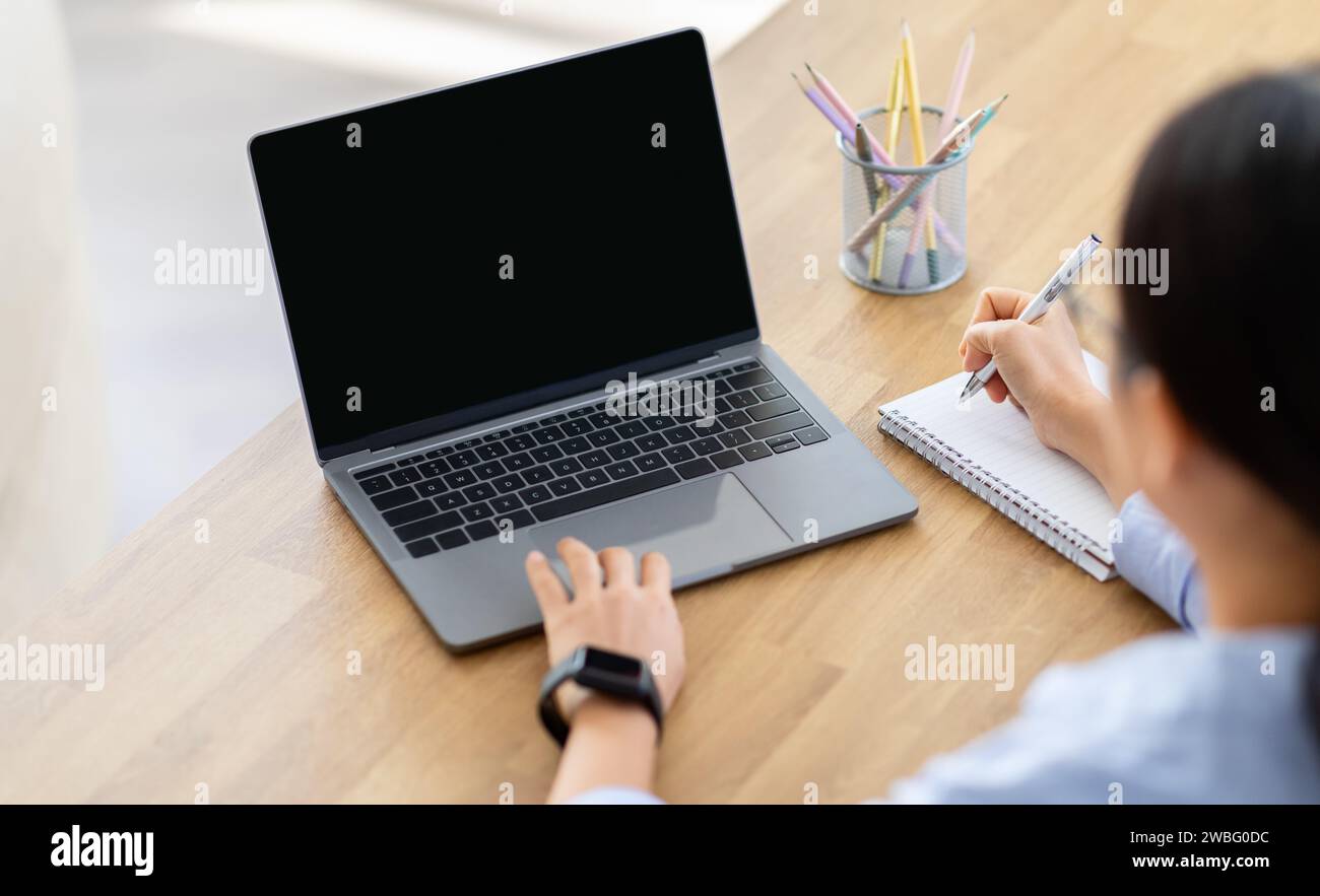 High angle view woman using laptop with blank screen Stock Photo