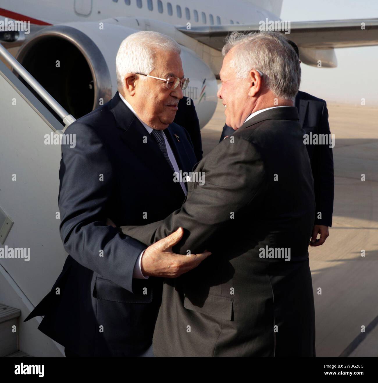 (240110) -- AQABA (JORDAN), Jan. 10, 2024 (Xinhua) -- King Abdullah II (R) of Jordan welcomes Palestinian President Mahmoud Abbas at the King Hussein International Airport in Aqaba, Jordan, on Jan. 10, 2024. Jordan, Egypt and Palestine stressed Wednesday their rejection of any Israeli plans to displace Palestinians in the West Bank and the Gaza Strip. (Royal Hashemite Court/Handout via Xinhua) Stock Photo