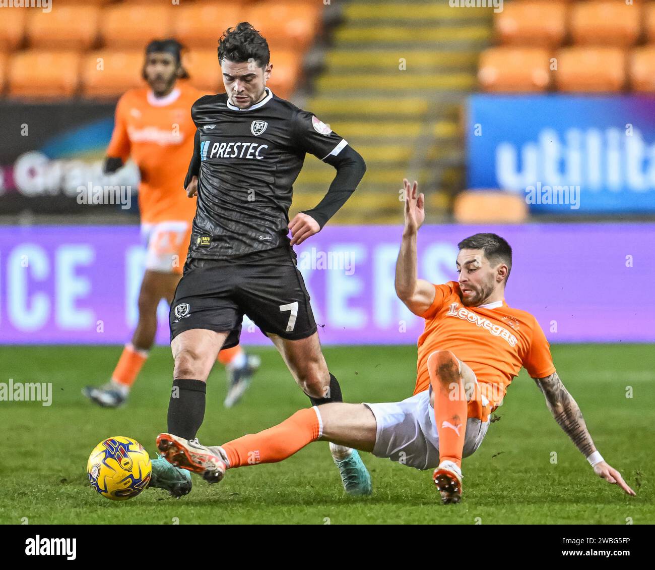 Joe Powell of Burton Albion is tackled by Owen Dale of Blackpool during the Bristol Street Motors Trophy match Blackpool vs Burton Albion at Bloomfield Road, Blackpool, United Kingdom, 10th January 2024 (Photo by Craig Thomas/News Images) in, on 1/10/2024. (Photo by Craig Thomas/News Images/Sipa USA) Credit: Sipa USA/Alamy Live News Stock Photo