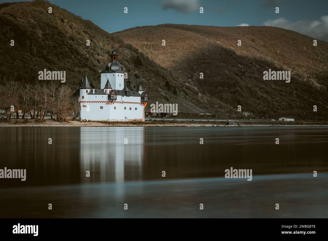 A majestic medieval castle is perched atop a picturesque small island ...