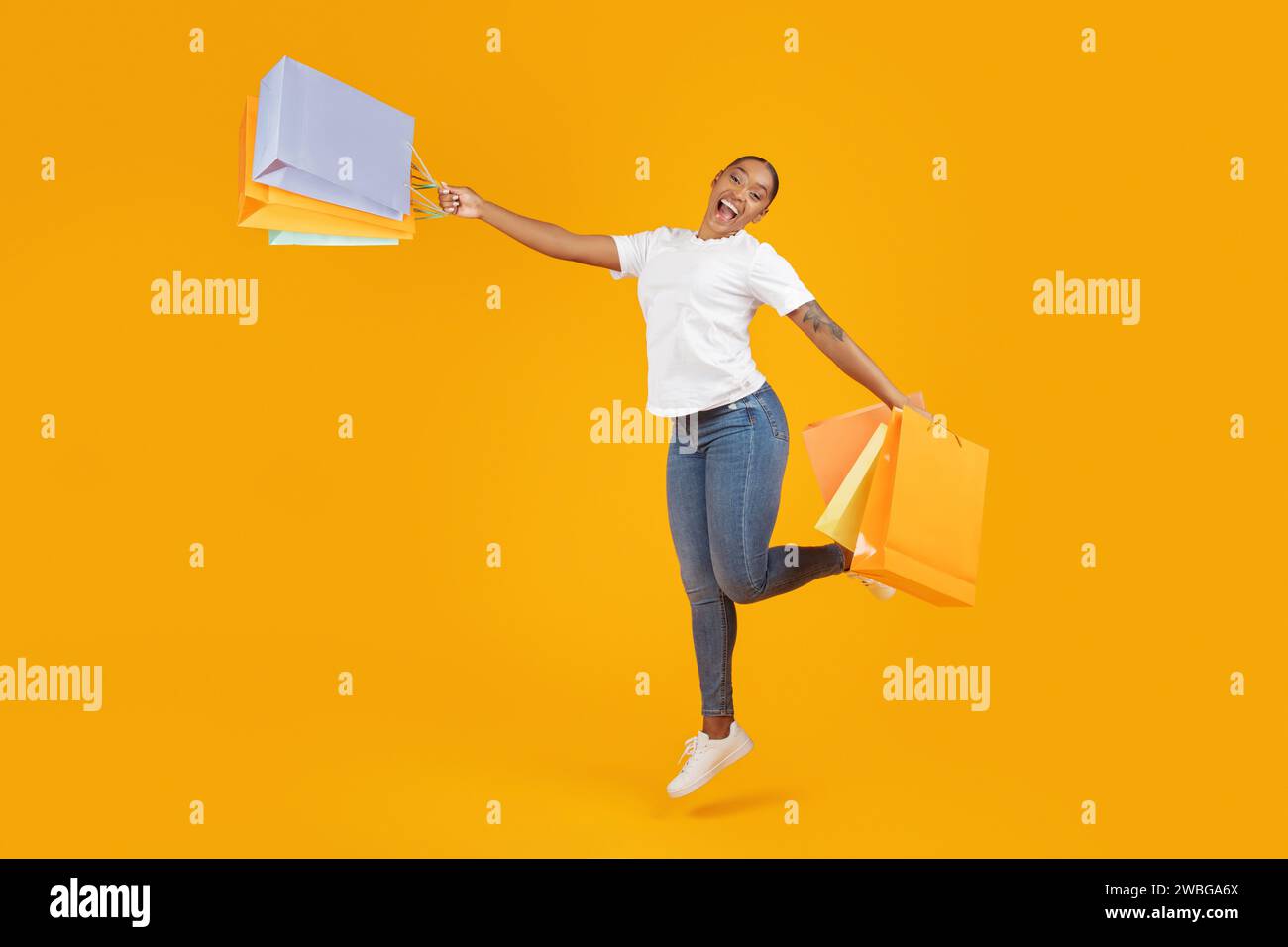 Excited young woman jumps hi-res stock photography and images - Alamy
