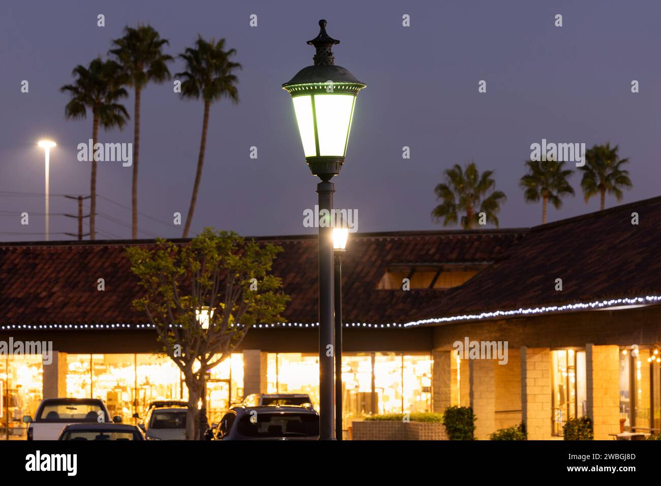 Lamps illuminate the twilight in downtown Brea, California, USA. Stock Photo
