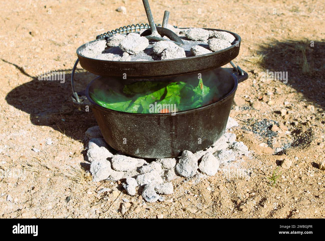 Outdoor Dutch Oven cooking in the Arizona Desert - Outdoor cast iron cooking Stock Photo