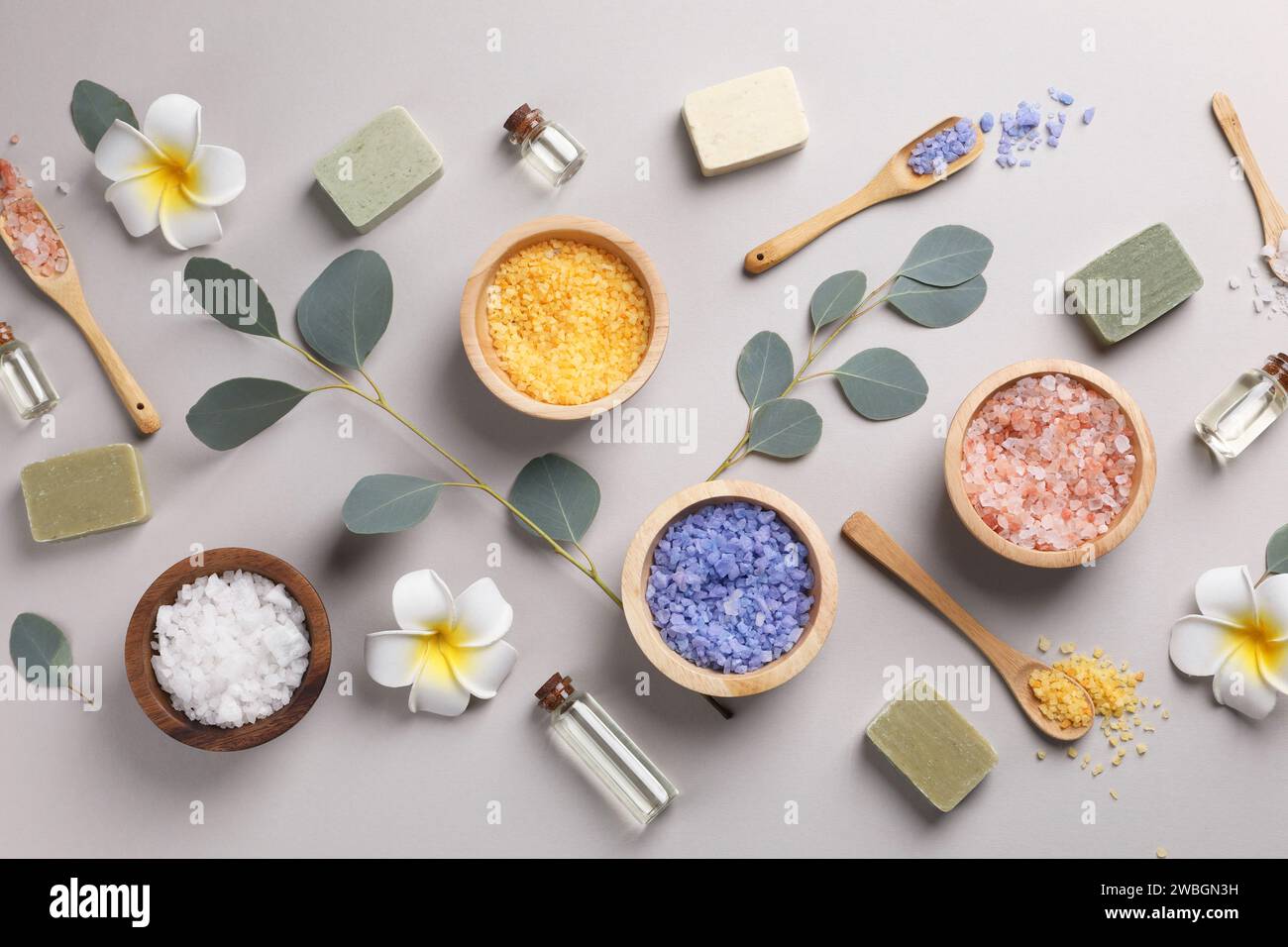 Flat lay composition with spa products and eucalyptus branches on grey ...