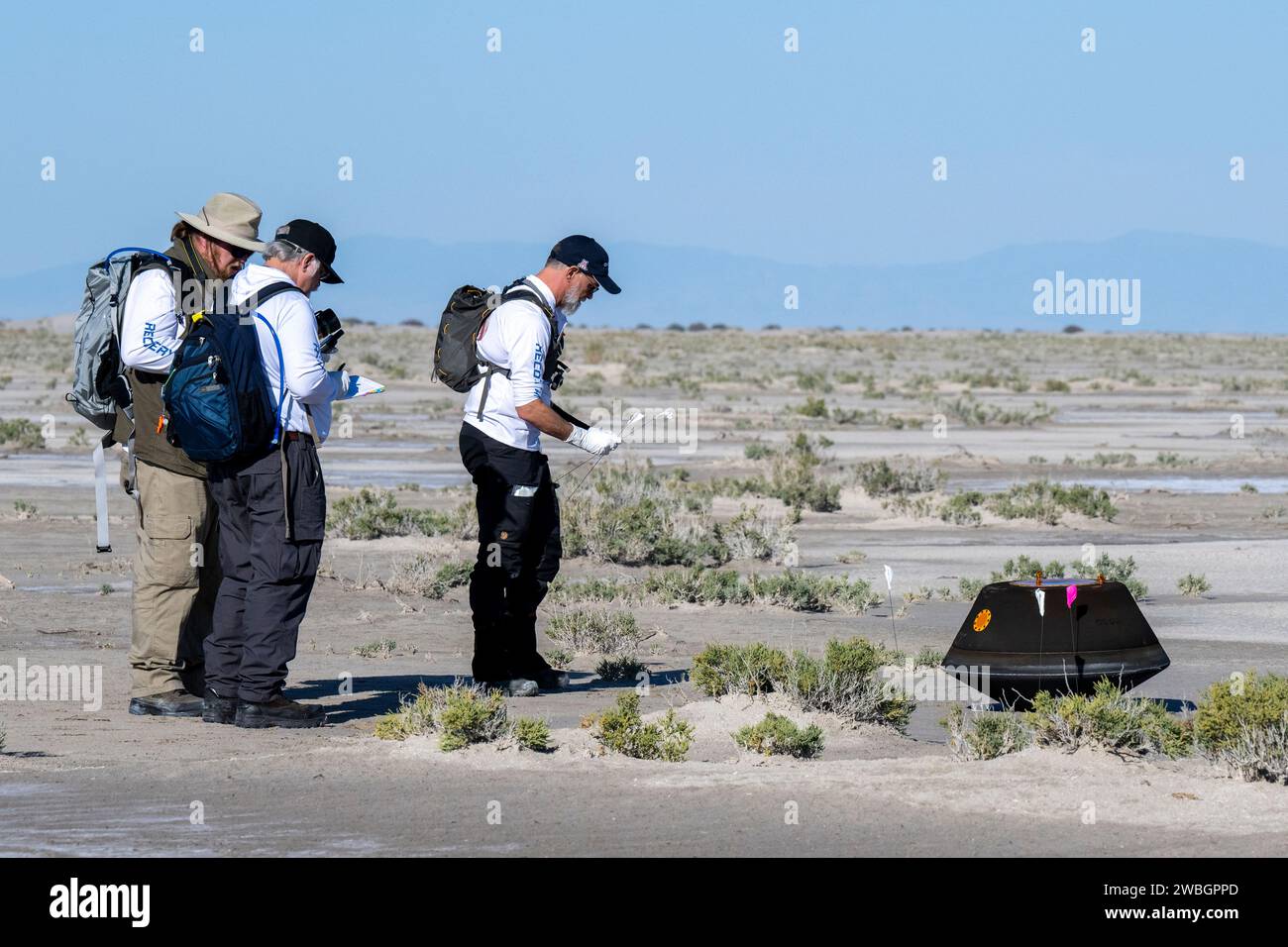 From left to right, NASA Astromatierals Curator Francis McCubbin, NASA Sample Return Capsule Science Lead Scott Sandford, and University of Arizona OSIRIS-REx Principal Investigator Dante Lauretta, collect science data, Sunday, Sept. 24, 2023, shortly after the sample return capsule from NASA’s OSIRIS-REx mission landed at the Department of Defense's Utah Test and Training Range. The sample was collected from the asteroid Bennu in October 2020 by NASA’s OSIRIS-REx spacecraft. Photo Credit: (NASA/Keegan Barber) Stock Photo