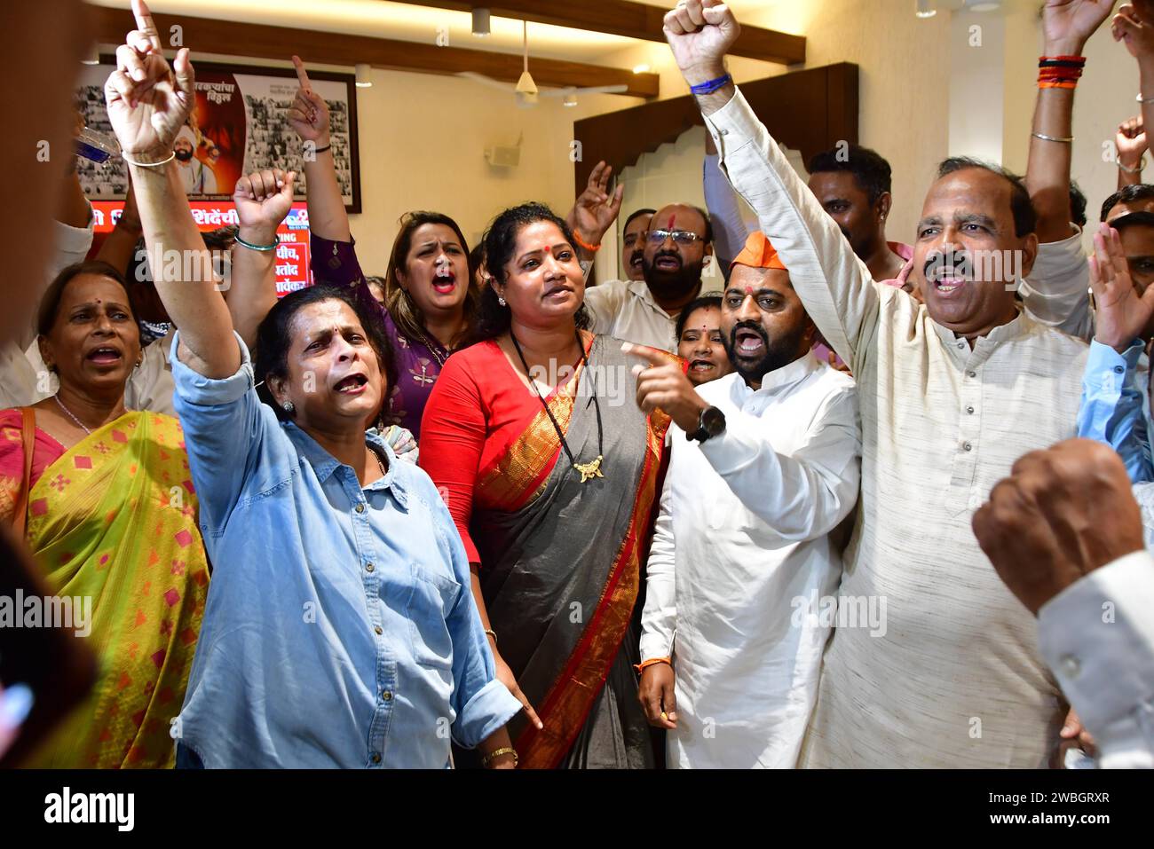 MUMBAI, INDIA - JANUARY 10: Shiv Sena (Shinde faction) workers celebrate after the verdict in the MLA disqualification case came in the favour, at Balasaheb Bhavan on January 10, 2024 in Mumbai, India. The Maharashtra Legislative Assembly Speaker Rahul Narwekar today held that Eknath Shinde led faction was the real Shiv Sena when the rival faction emerged within the party on June 22, 2022. He has refused to disqualify any member from both the factions, led by Shinde and Uddhav Thackeray. Both the factions had filed 34 petitions against each other before the speaker in 2022, seeking the disqu Stock Photo