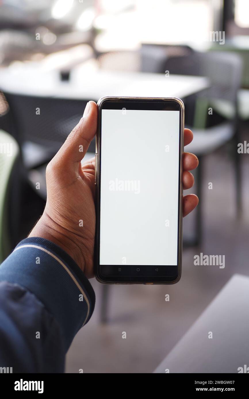 young man hand using smart phone with white screen at cafe Stock Photo ...
