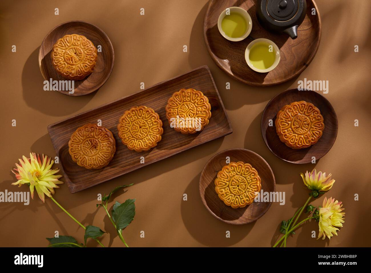A set of tea in black color and several tasty mooncakes are arranged on ...