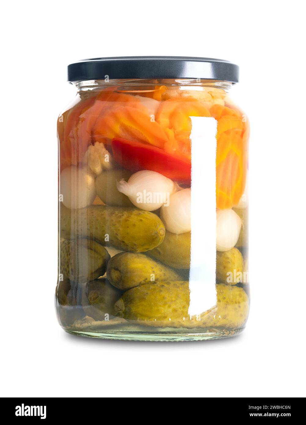 Mixed vegetables, pickled grill and barbecue mix in a glass jar. Carrots, pearl onions, bell peppers, baby corn and pickles, preserved in a brine. Stock Photo