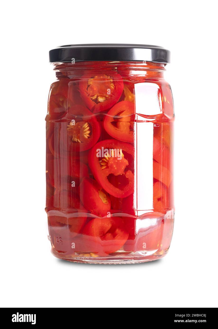 Red jalapeno slices, pickled in a glass jar. Medium-sized hot, red chili peppers, cut into cross sections, pasteurized and preserved in a brine. Stock Photo