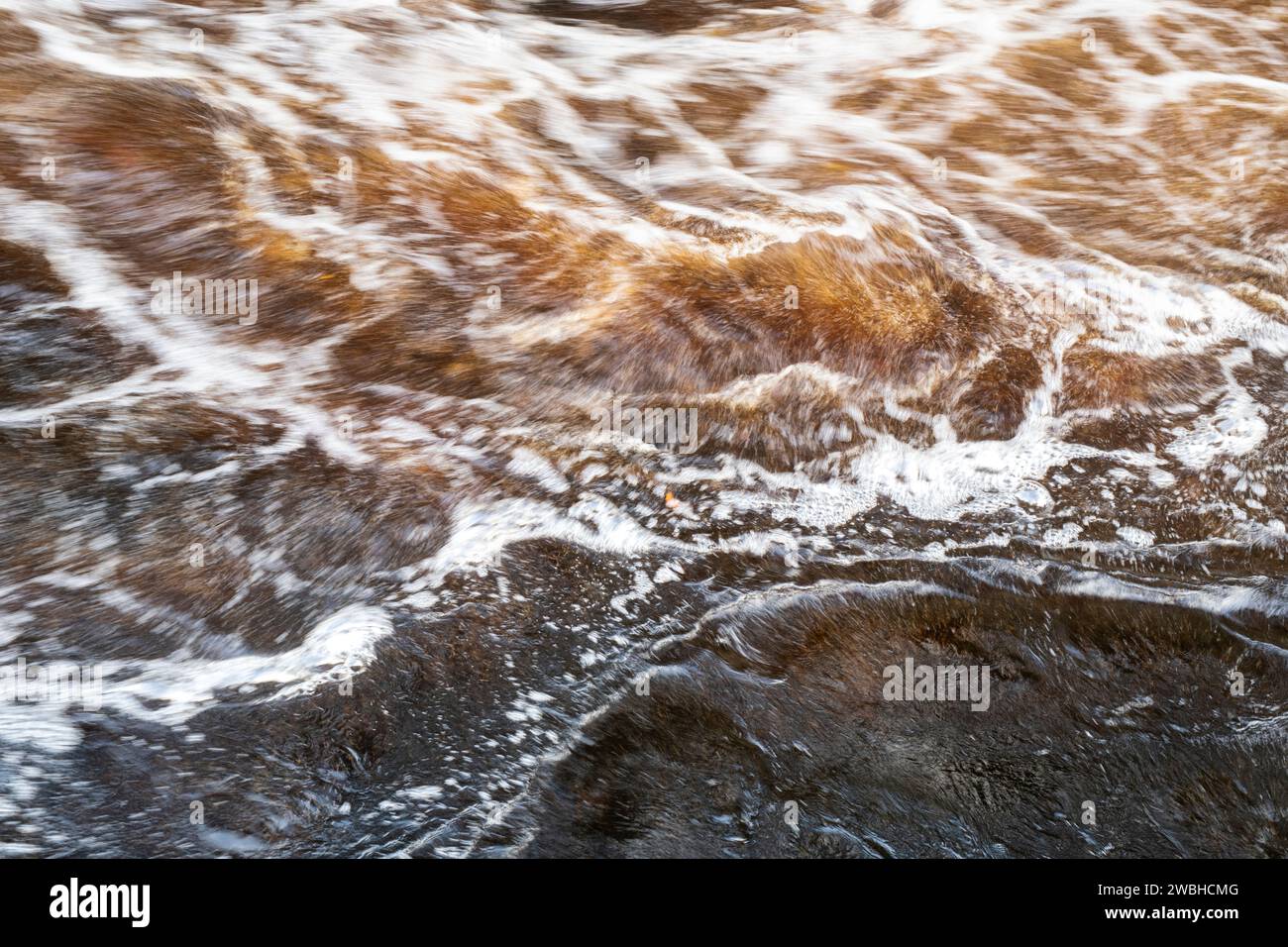 Fast flowing water. River Findhorn, Morayshire, Scotland. Long exposure abstract Stock Photo