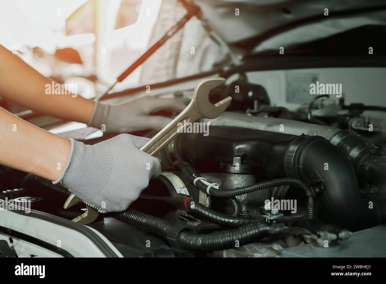 Car mechanic working on car engine, car maintenance concept Stock Photo