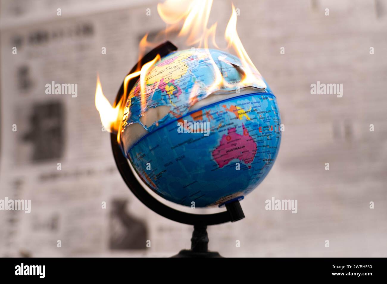 Model globe on fire. Planet Earth Burning. Global Warming and Climate Change Concept. Stock Photo