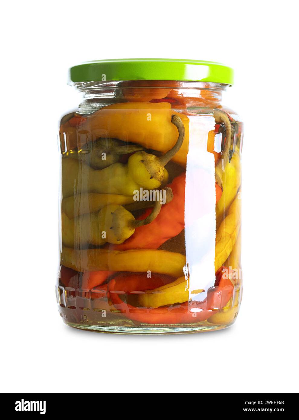 Pepperonis, pickled cayenne peppers in a glass jar. Green, red, and yellow fruits of moderately hot chili peppers, pasteurized and preserved in brine. Stock Photo