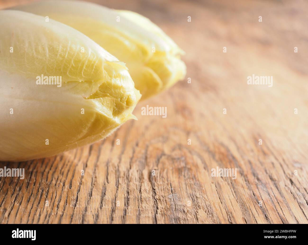 Close up of chicory on a wooden kitchen table with space for text or image Stock Photo
