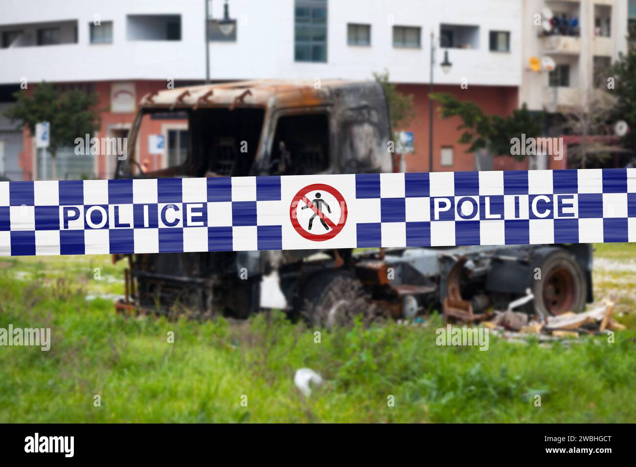 Truck burnt by a pyromaniac with a police tape with written in it in English 'Police'. Stock Photo