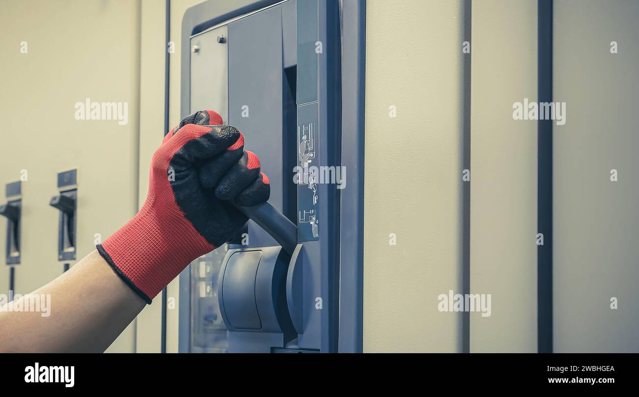 Electrical engineer tests the operation of the electric control cabinet ...