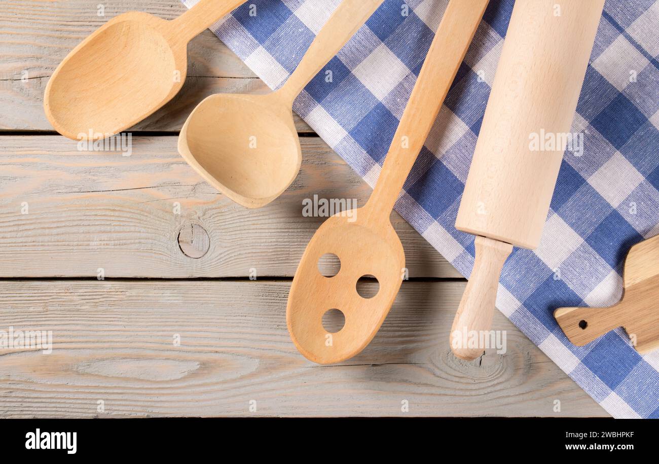 Kitchen Utensils and Towel Arrangement on Natural Wooden Background Stock Photo