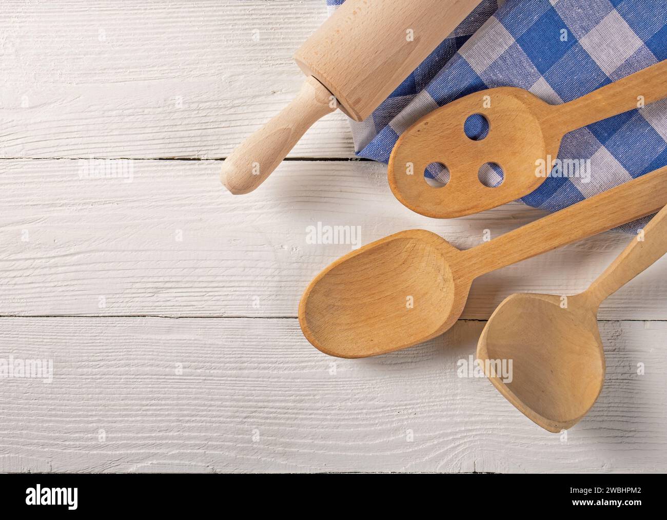 Top View of Wooden Kitchen Accessories and Towel on Natural Board Background Stock Photo