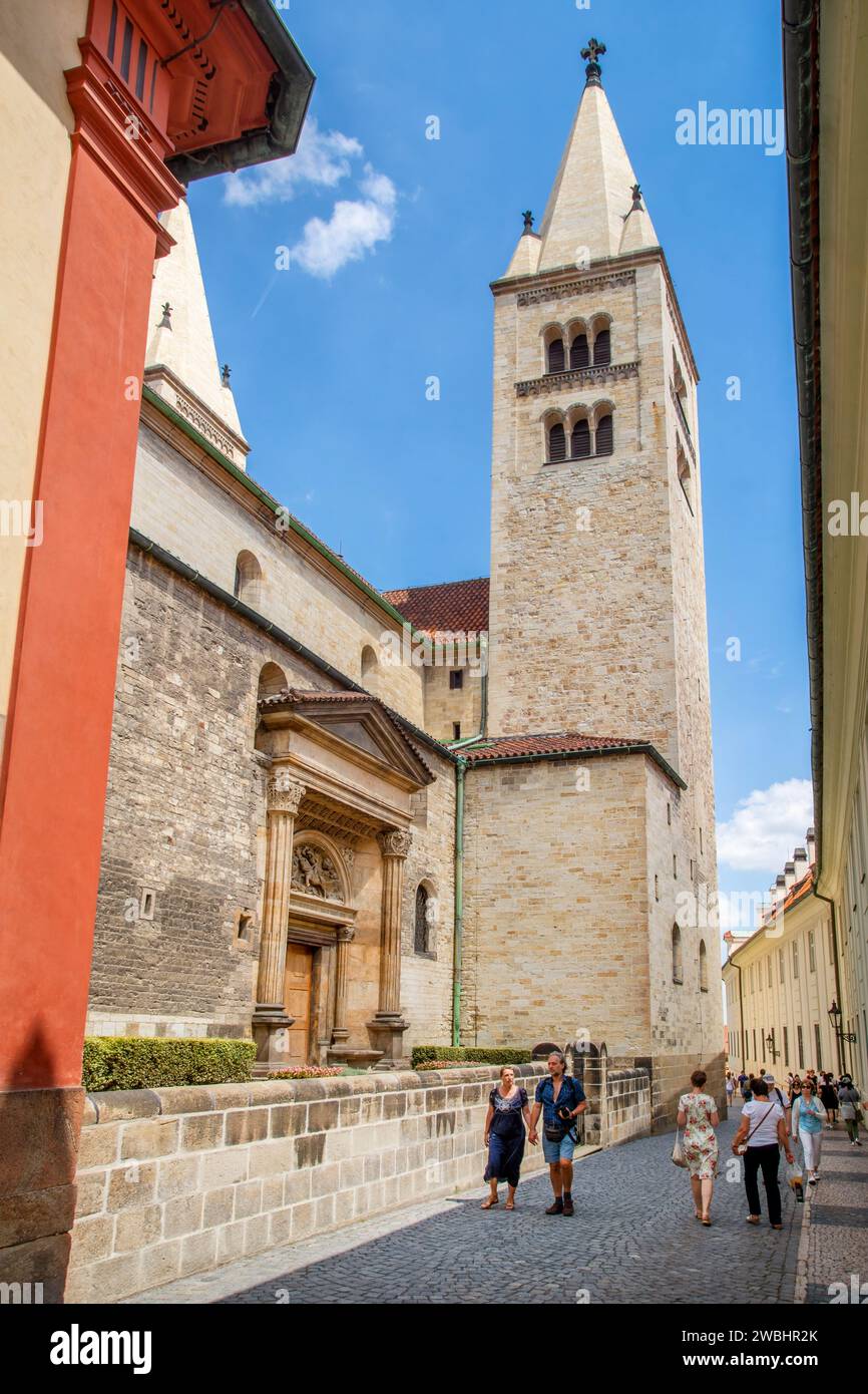 People walking down the back street where the St. George's Basilica is located, the oldest surviving church building within Prague Castle. (2016) Stock Photo
