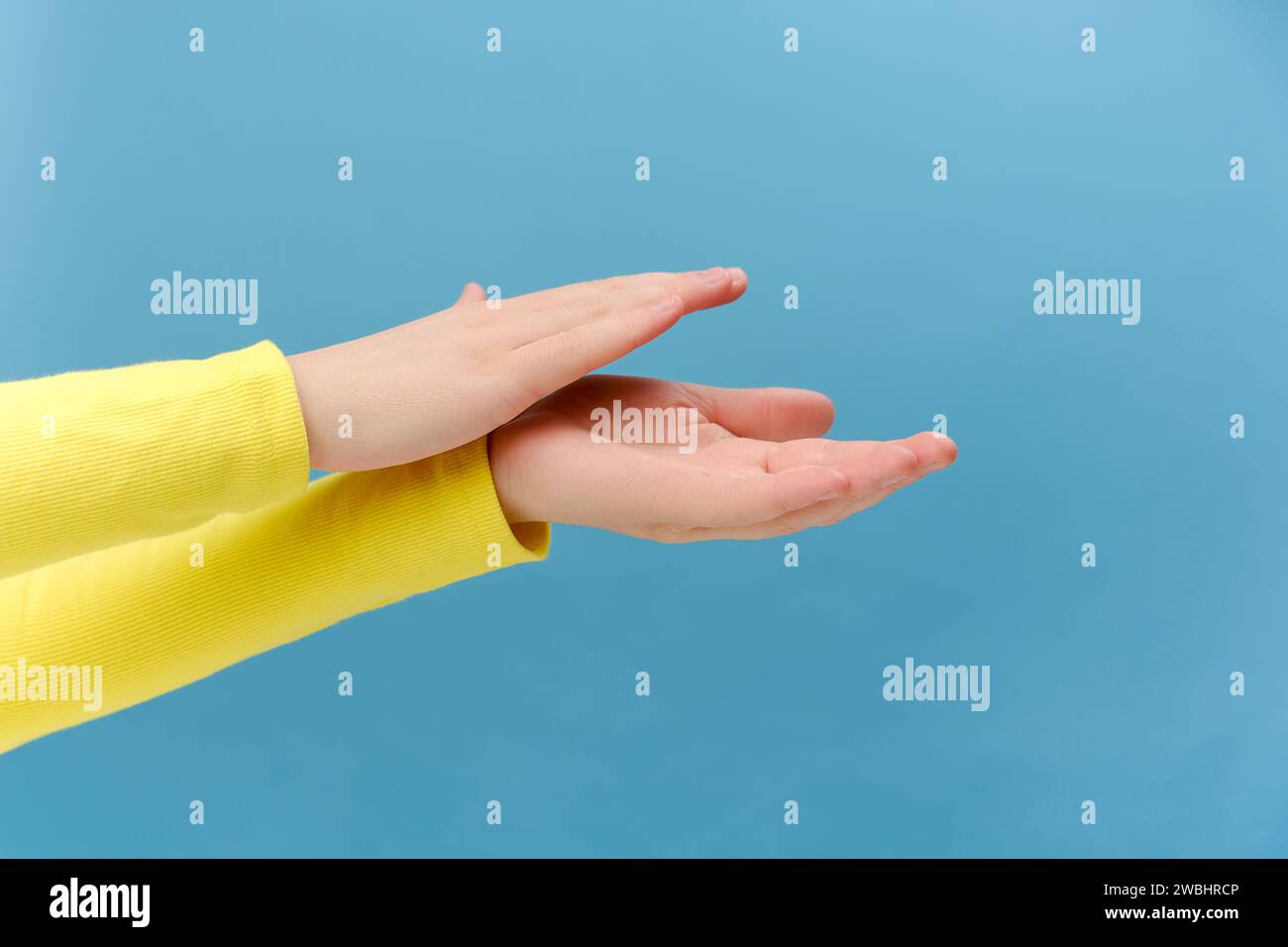 Close up of unknown young caucasian woman applauding, clapping hands congratulating with victory, satisfied with performance, bravo concept, posing is Stock Photo