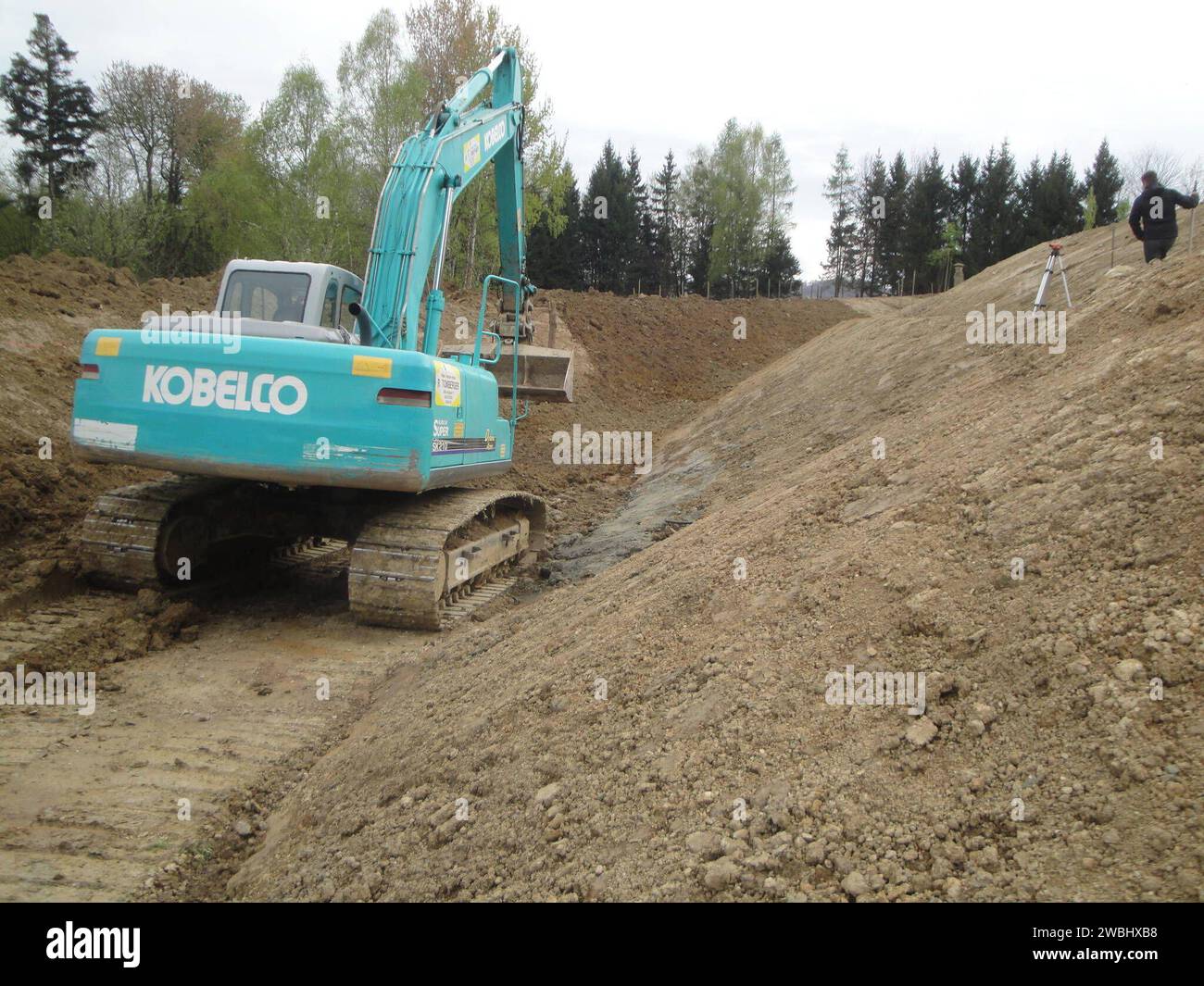 kobelco excavator at a construction site, heavy machinery for earthworks and building project kobelco Excavator at a construction site Stock Photo