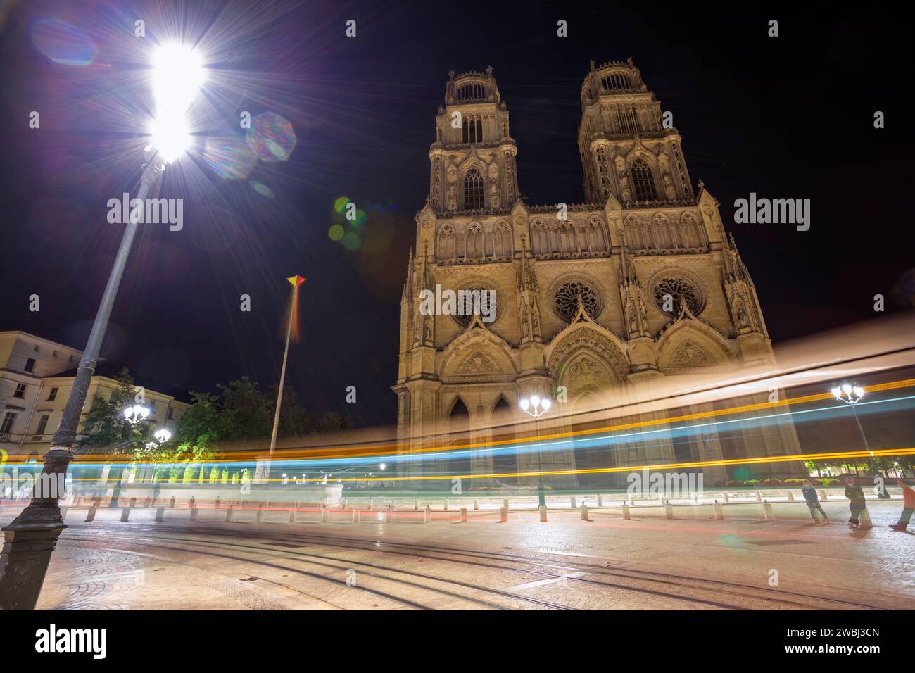 Europe, France, Centre-Val de Loire Region, Orléans, Cathedral of the Holy Cross of Orléans with passing Tram at Night Stock Photo