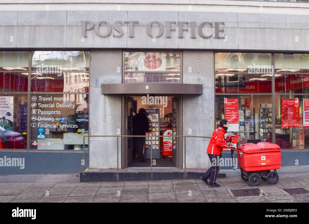 London, England, Uk. 11th Jan, 2024. A postal worker passes by the