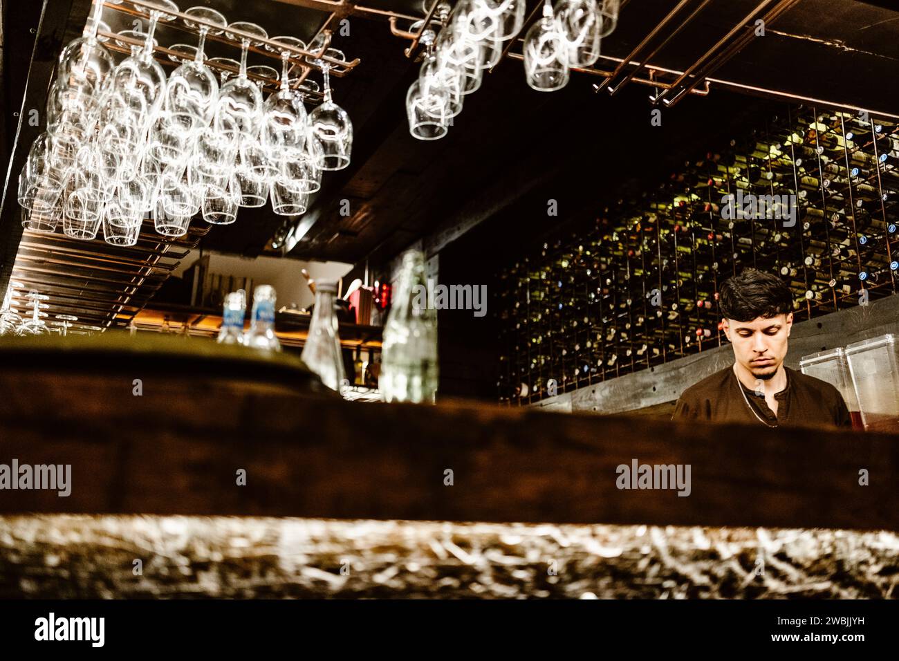 April 17, 2023 - Porto, Portugal: Portuguese barman working in the bar and preparing drinks Stock Photo
