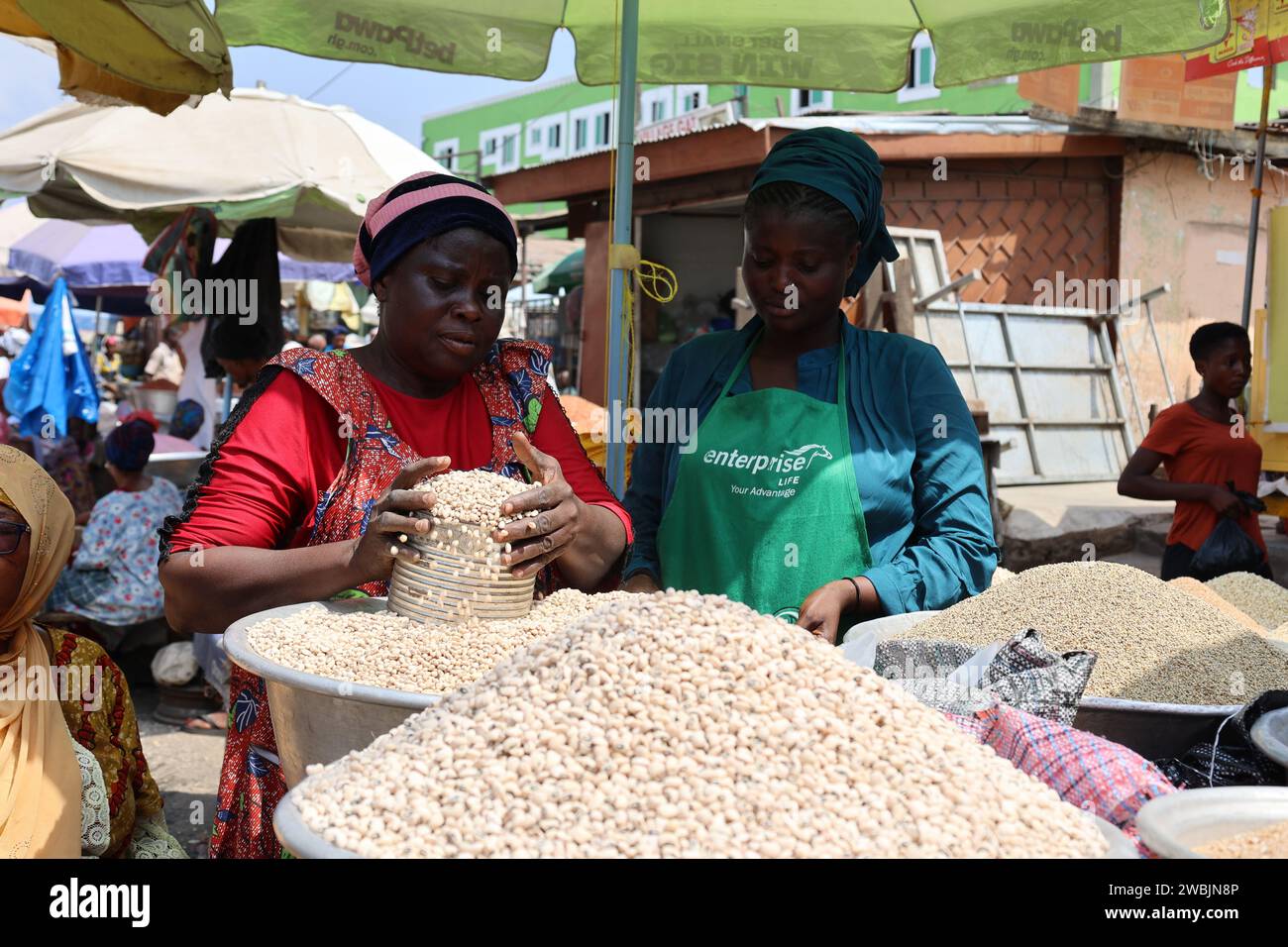 Accra, Ghana. 10th Jan, 2024. Vendors sell goods at a market in Accra