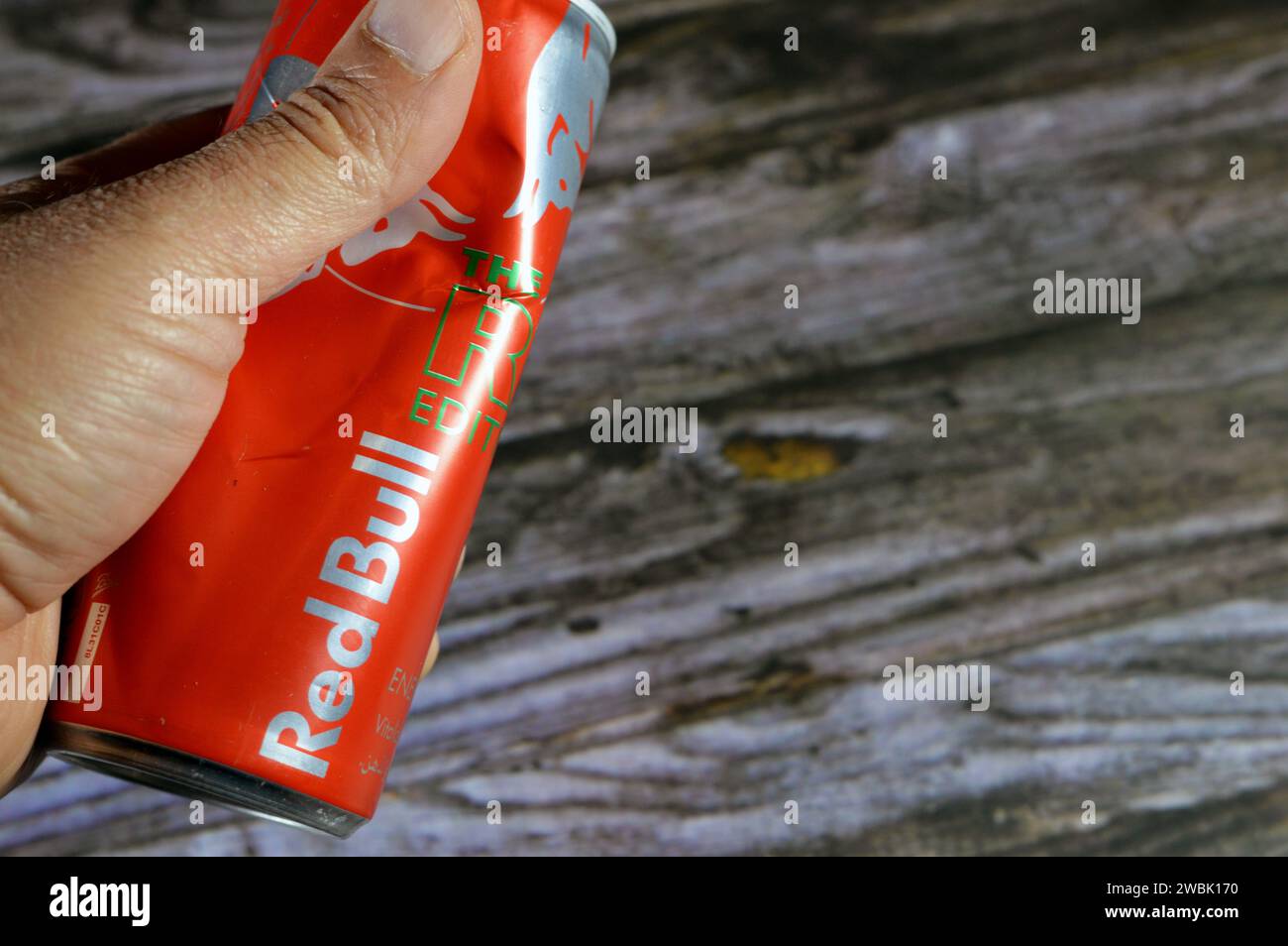 Cairo, Egypt, January 9 2024: Crushed dented Red Bull energy drink, a brand of energy drinks created and owned by the Austrian company Red Bull GmbH, Stock Photo