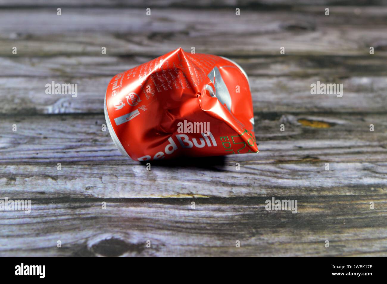 Cairo, Egypt, January 9 2024: Crushed dented Red Bull energy drink, a brand of energy drinks created and owned by the Austrian company Red Bull GmbH, Stock Photo