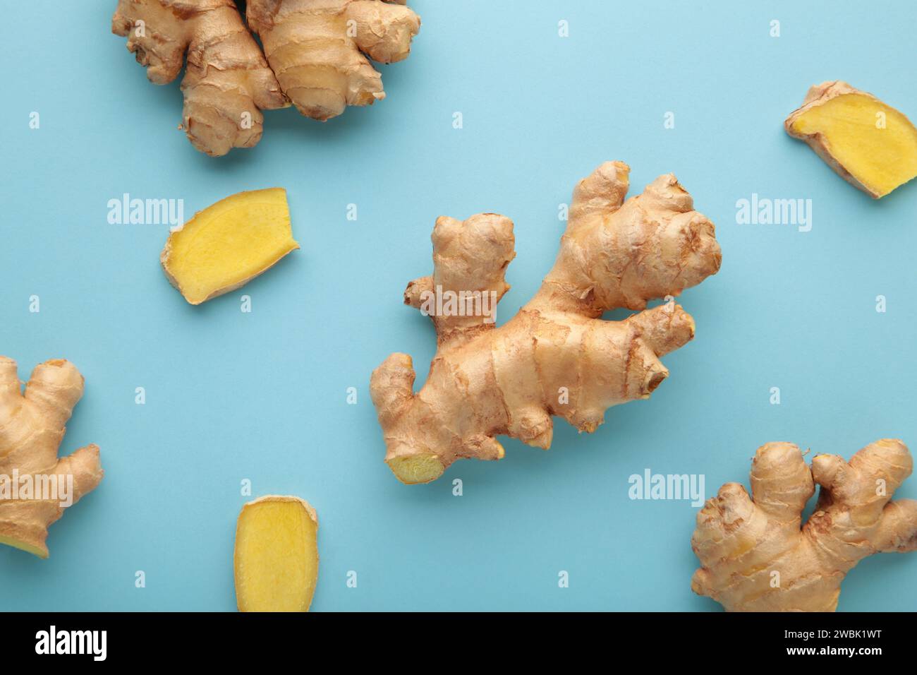 Fresh ginger root on blue background. Vitamins. Top view. Stock Photo