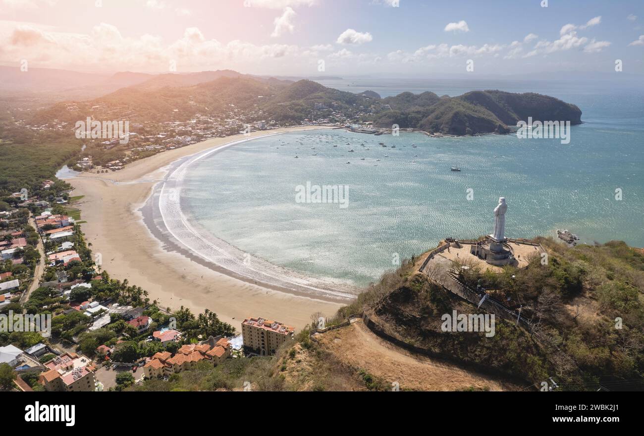 Jesus christ monument on rock hill in Nicaragua San Juan Del Sur aerial drone view Stock Photo