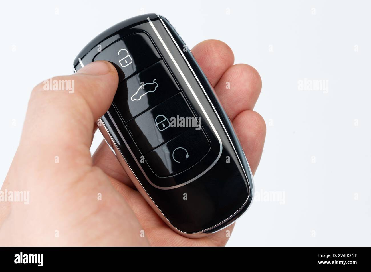 Unlocking car with key button holding in hand isolated Stock Photo
