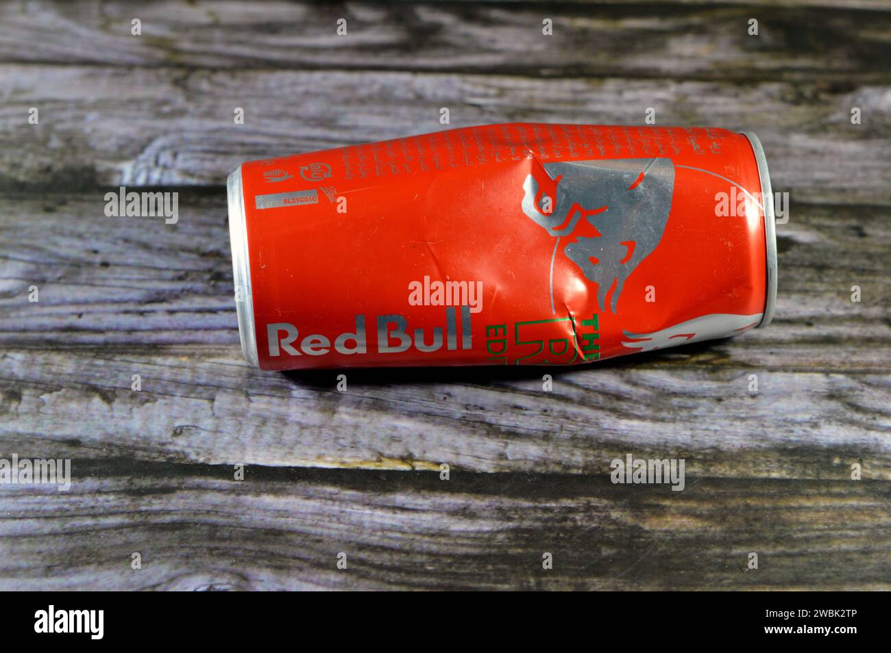 Cairo, Egypt, January 9 2024: Crushed dented Red Bull energy drink, a brand of energy drinks created and owned by the Austrian company Red Bull GmbH, Stock Photo