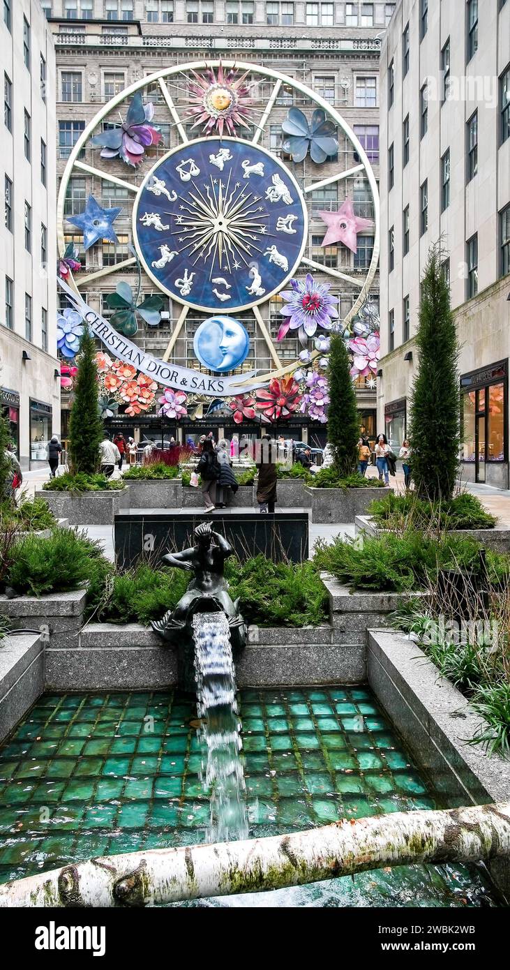 NEW YORK CITY, NEW YORK, USA - JANUARY 10, 2024: Beautiful Christmas decoration on Saks at Fifth avenue with pedestrians, vertical view Stock Photo