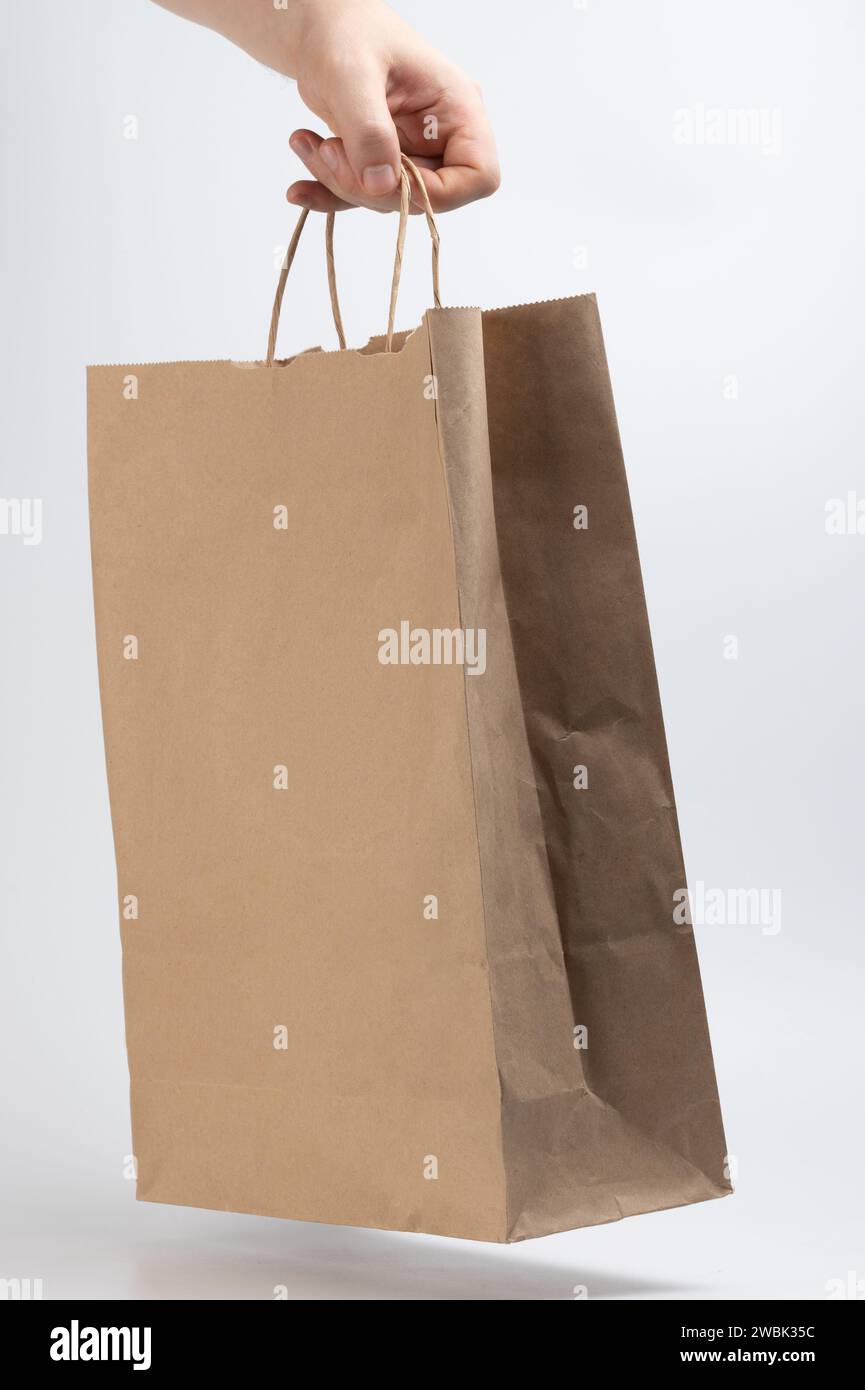 Carrying purchase in recycled bag with handle isolated on white studio background Stock Photo