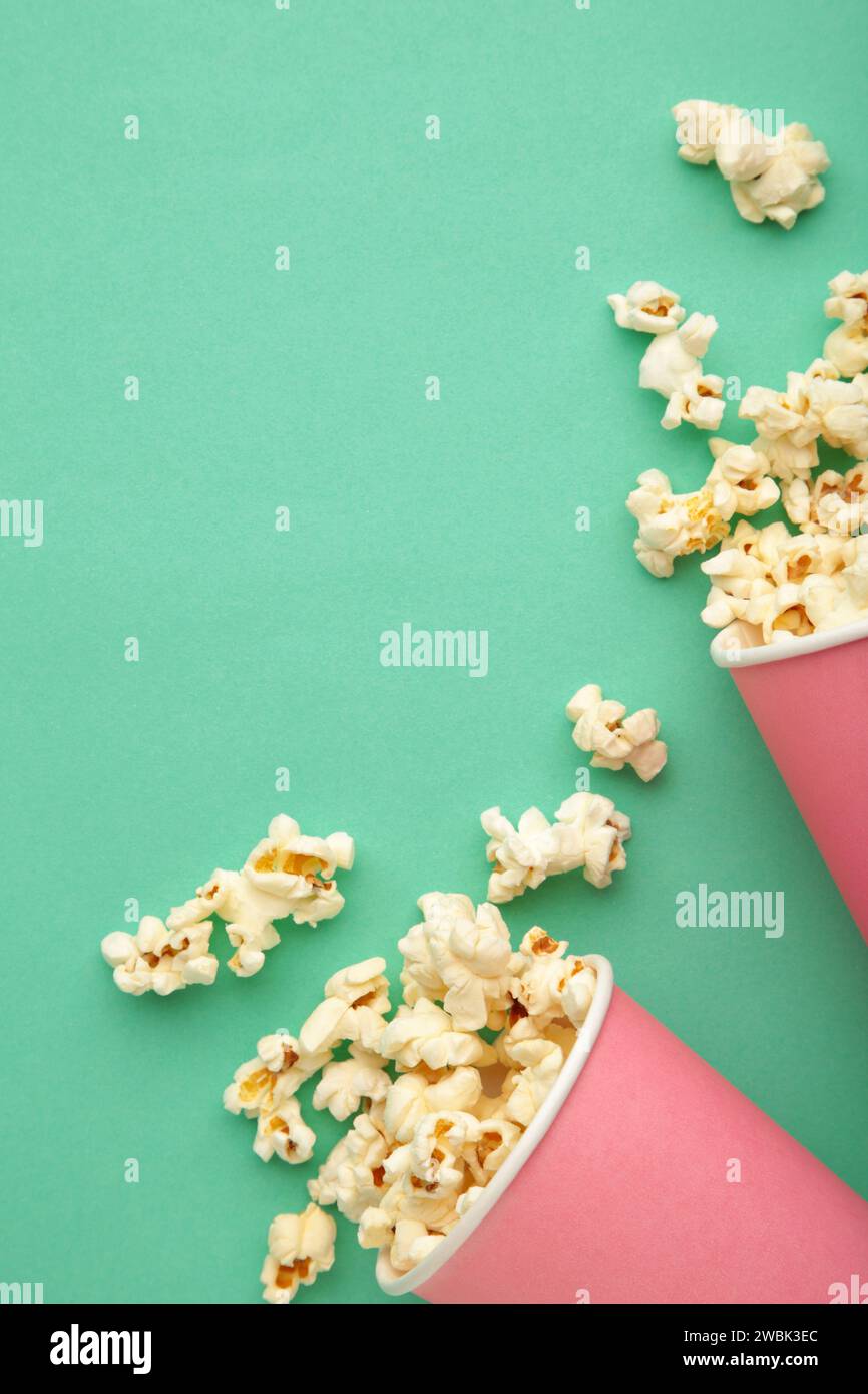 Popcorn in pink cups. Three cups of popcorn on mint background. Sweet