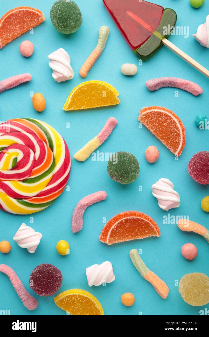 Colorful candies lollipops and jelly on pink background. Top view ...