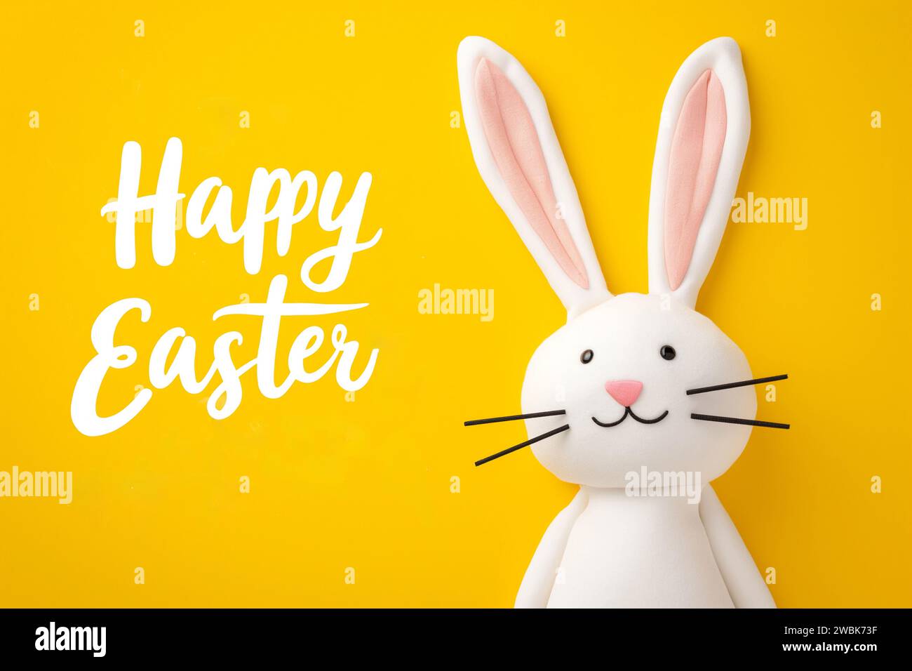 Happy easter, Happy Easter Greeting with Cartoon Bunny on Bright Yellow Background and Playful White Cursive Font Stock Photo