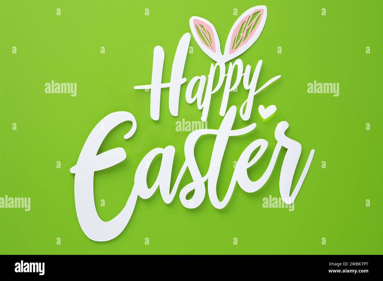 Fresh Spring Greeting: Happy Easter with Bunny Ears on Lively Green Background Stock Photo