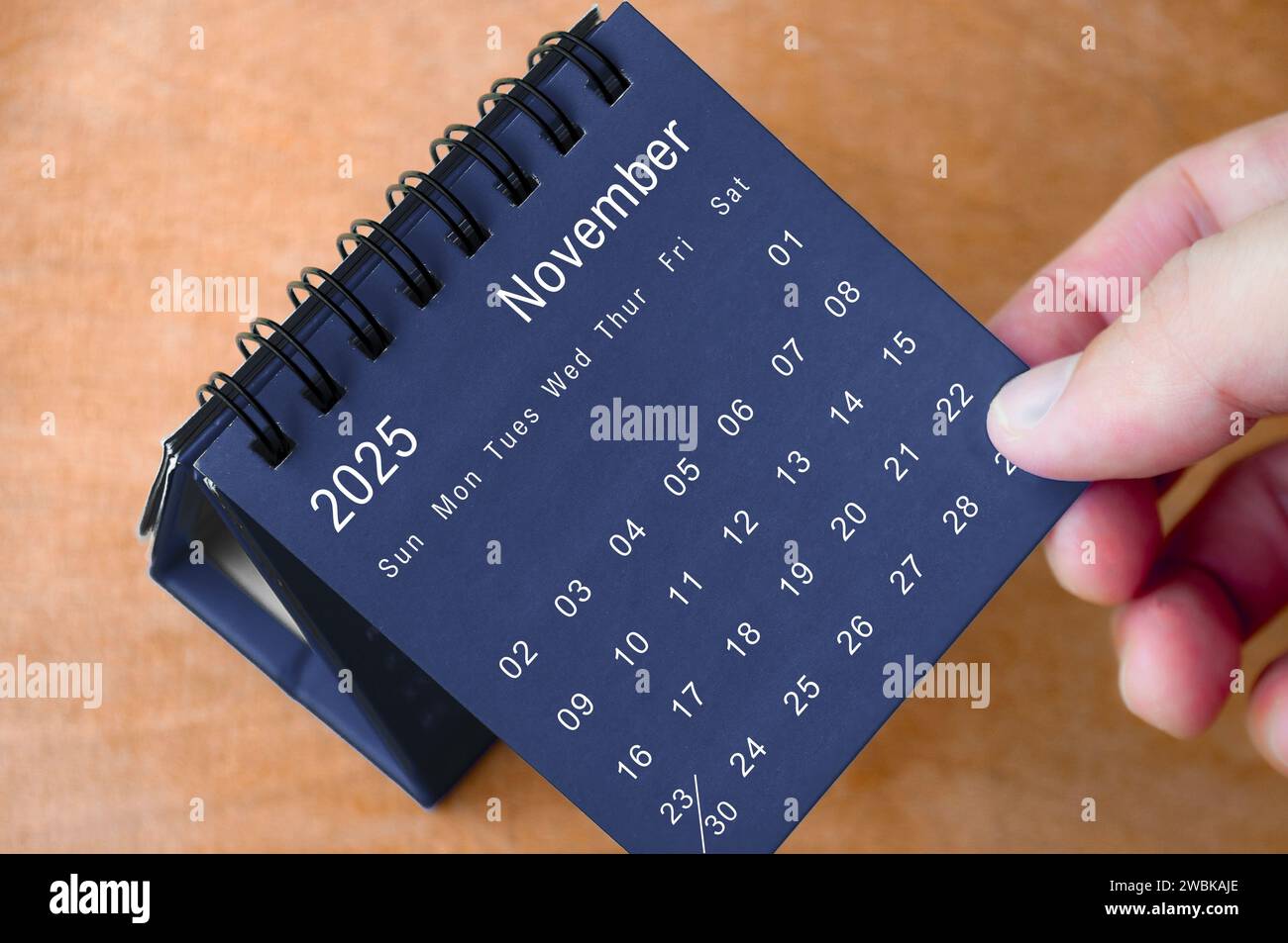 November 2025 black and white calendar on wooden desk. Calendar and new month concept Stock
