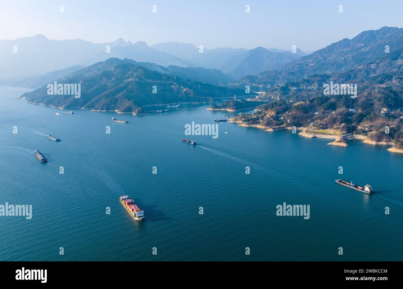 Yichang. 11th Jan, 2024. An aerial drone photo taken on Jan. 11, 2024 shows vessels sailing on the Zigui section of the Yangtze River in Yichang, central China's Hubei Province. The cargo throughput via the Three Gorges Dam, the world's largest hydropower project on the upper stream of the Yangtze River, reached a record high of 172.34 million tonnes in 2023, up 7.95 percent year on year, according to the China Three Gorges Corporation. Credit: Zheng Jiayu/Xinhua/Alamy Live News Stock Photo